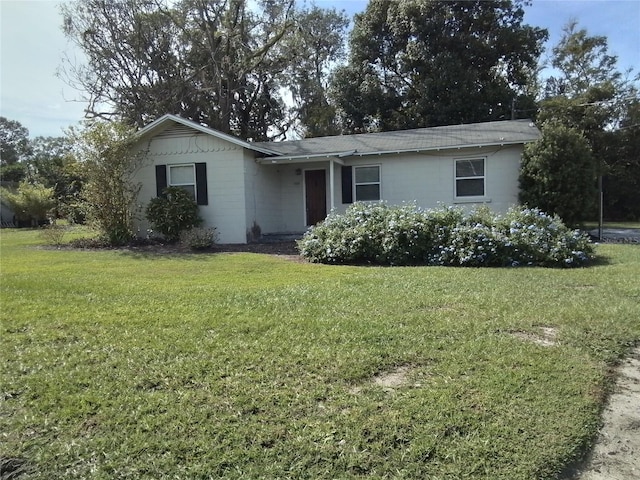 ranch-style home with a front lawn