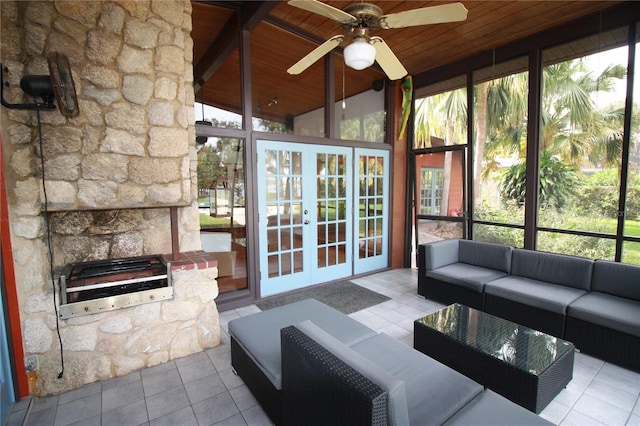 unfurnished sunroom featuring wood ceiling, vaulted ceiling, and ceiling fan