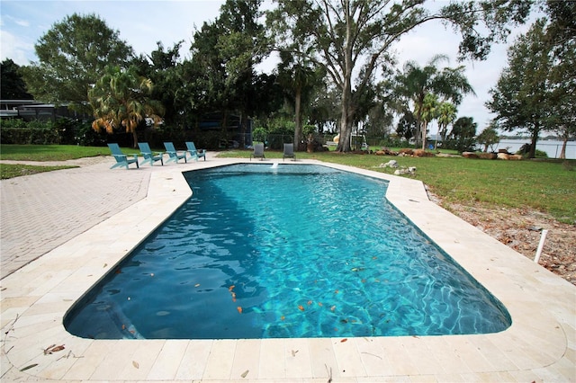 view of swimming pool with a lawn and a patio area