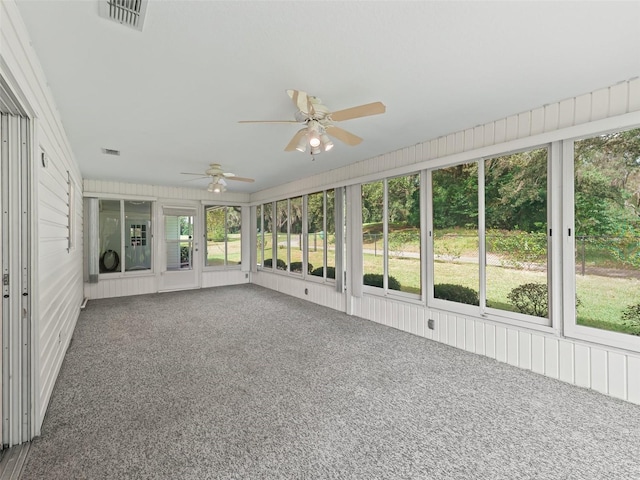 unfurnished sunroom with ceiling fan