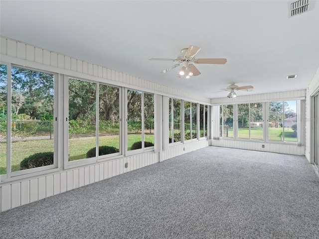 unfurnished sunroom with ceiling fan