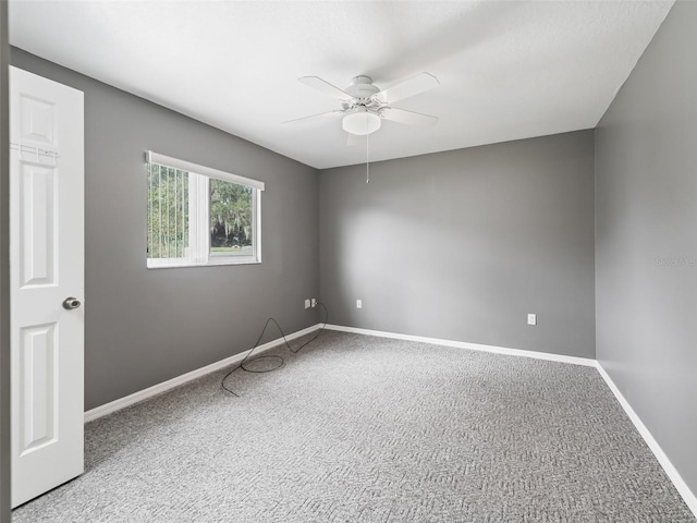 empty room featuring carpet and ceiling fan