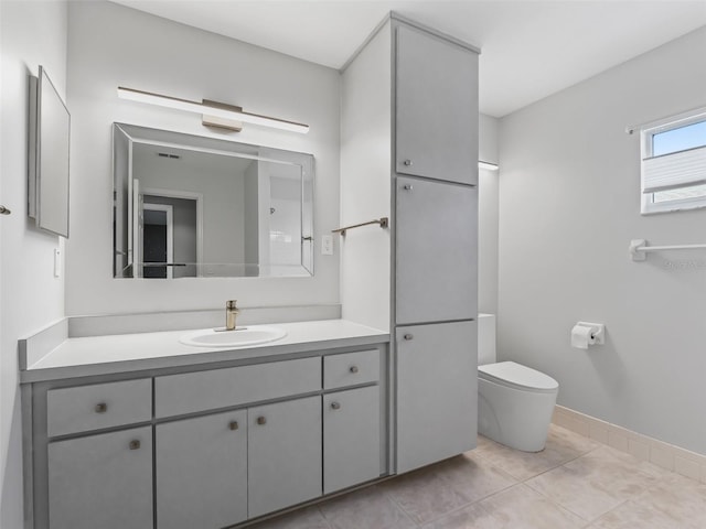 bathroom with vanity, tile patterned flooring, and toilet