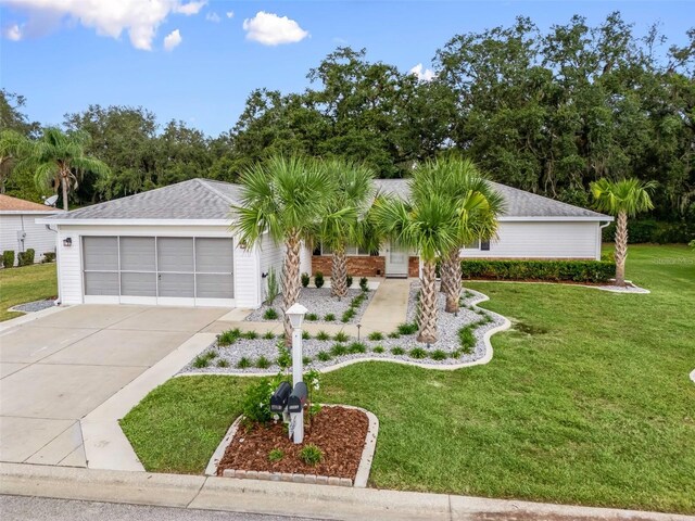 single story home featuring a garage and a front yard