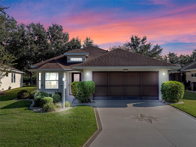 view of front of house with a garage and a yard