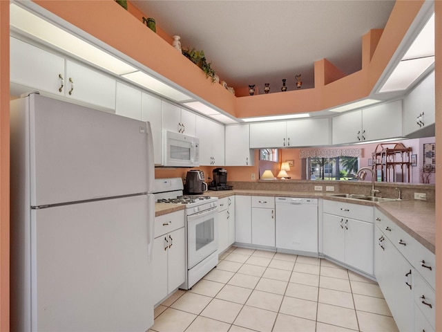 kitchen with white cabinetry, white appliances, sink, and light tile patterned floors