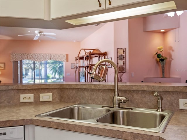 kitchen featuring ceiling fan, sink, white dishwasher, and white cabinets