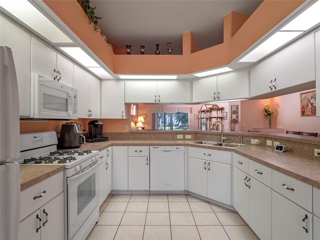 kitchen with white cabinets, white appliances, and sink