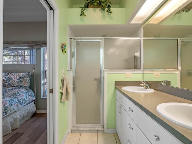 bathroom featuring vanity, hardwood / wood-style flooring, and a shower with shower door