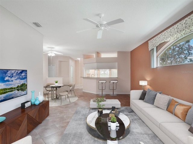 tiled living room featuring ceiling fan