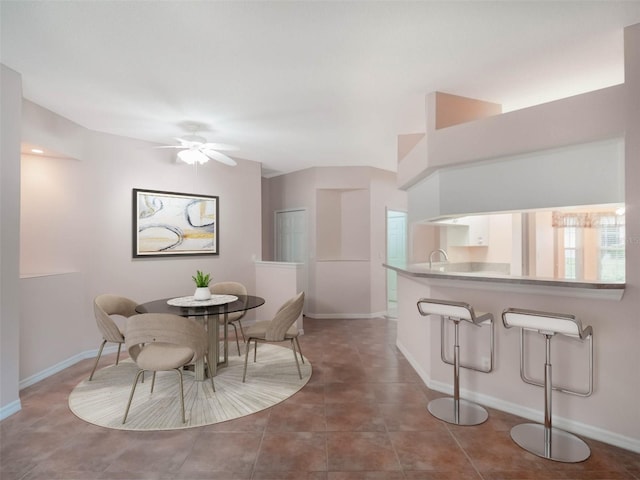 dining area featuring ceiling fan and tile patterned floors