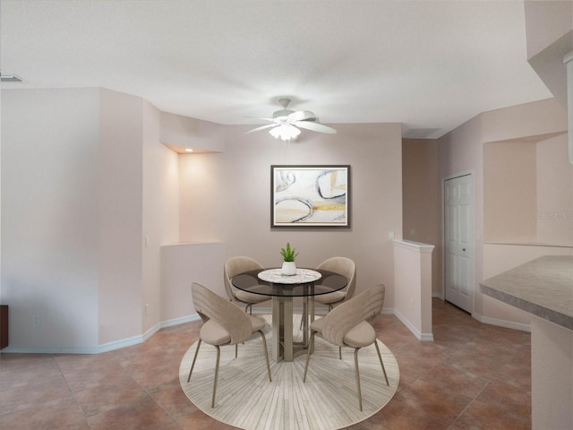 dining room featuring tile patterned flooring and ceiling fan