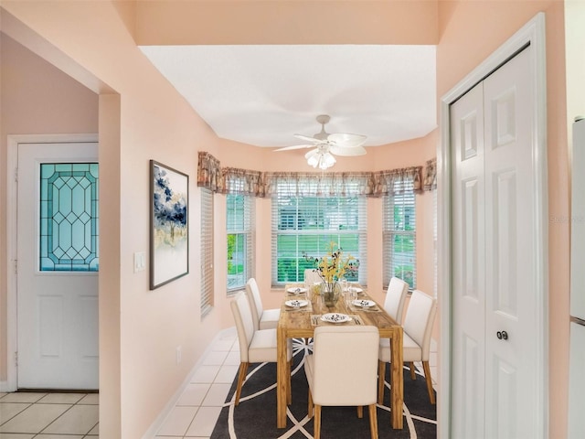 dining area featuring light tile patterned floors and ceiling fan