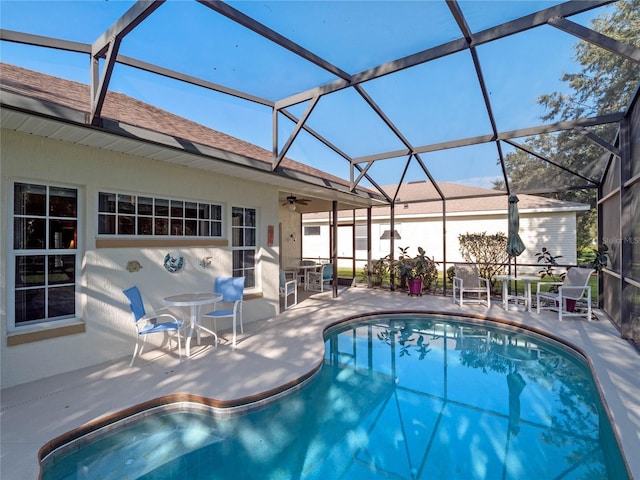 view of swimming pool featuring a lanai and a patio