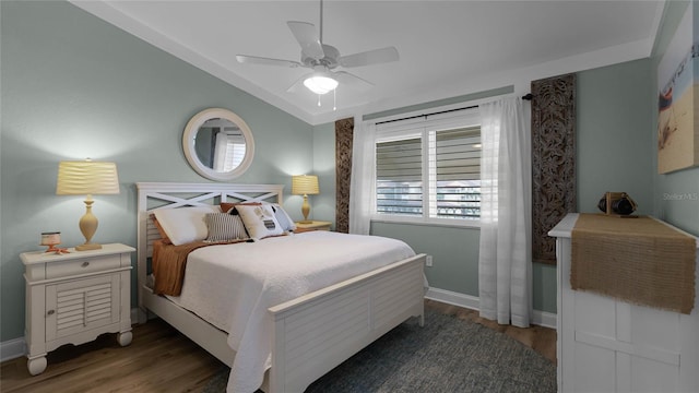 bedroom featuring ceiling fan and dark hardwood / wood-style flooring