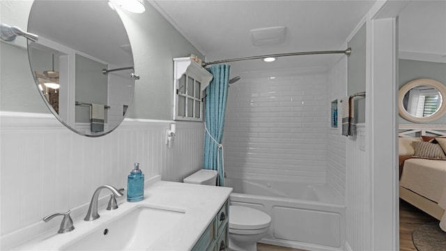 full bathroom with ornamental molding, vanity, hardwood / wood-style flooring, toilet, and shower / bathtub combination with curtain