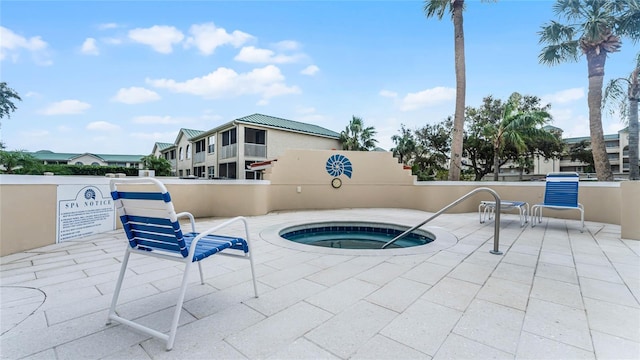 view of swimming pool featuring a community hot tub and a patio area