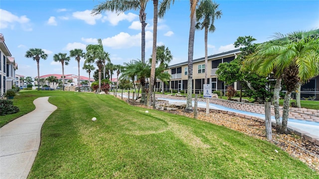 view of property's community featuring a lawn