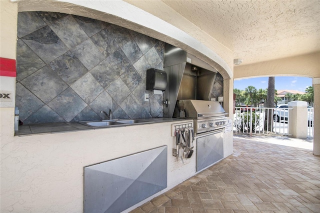 view of patio / terrace with area for grilling and sink