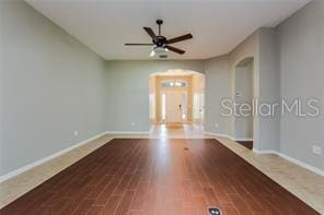 spare room with hardwood / wood-style flooring and ceiling fan