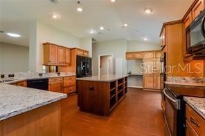 kitchen featuring light stone countertops, dark hardwood / wood-style flooring, a kitchen island, and black appliances