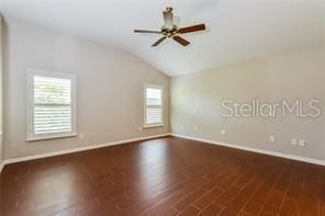 unfurnished room with ceiling fan, dark wood-type flooring, a healthy amount of sunlight, and vaulted ceiling