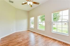 unfurnished room featuring plenty of natural light, ceiling fan, and light hardwood / wood-style flooring