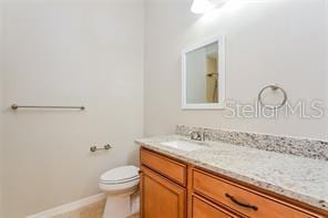 bathroom featuring vanity and toilet