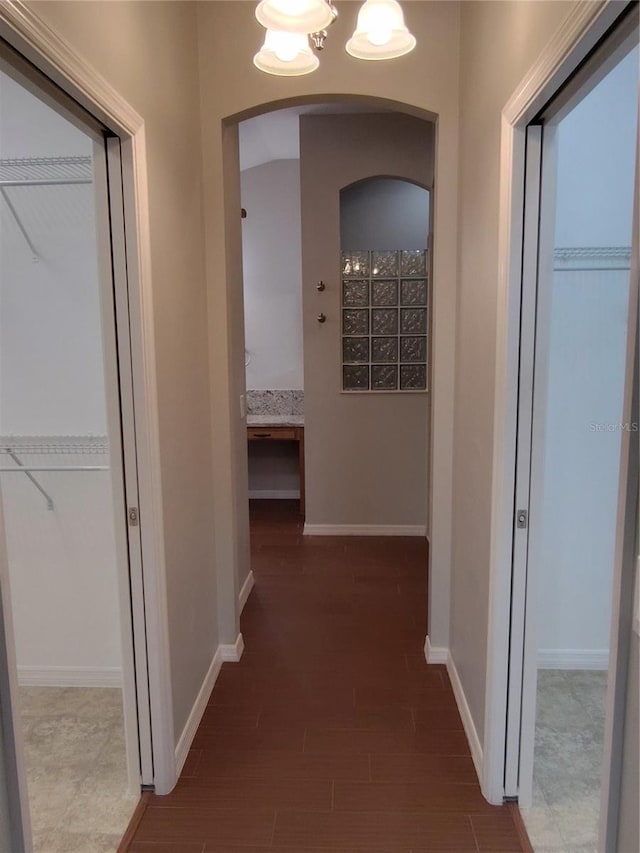 corridor with hardwood / wood-style floors