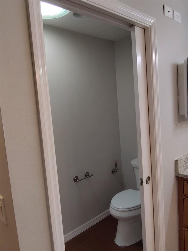 bathroom featuring tile patterned flooring, vanity, and toilet