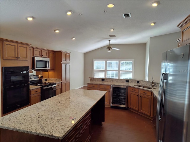 kitchen with wine cooler, dark hardwood / wood-style floors, vaulted ceiling, a kitchen island, and appliances with stainless steel finishes