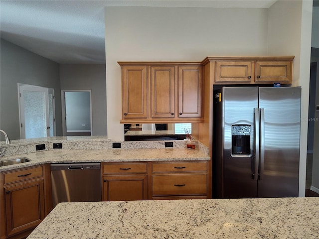 kitchen featuring light stone countertops, sink, and appliances with stainless steel finishes