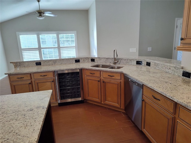 kitchen with dishwasher, sink, wine cooler, vaulted ceiling, and dark hardwood / wood-style floors