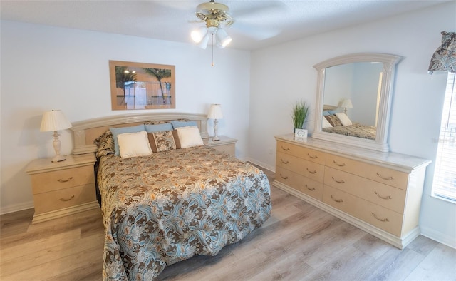 bedroom with ceiling fan and light hardwood / wood-style floors