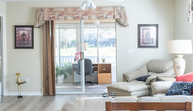 interior space with ceiling fan and light hardwood / wood-style flooring