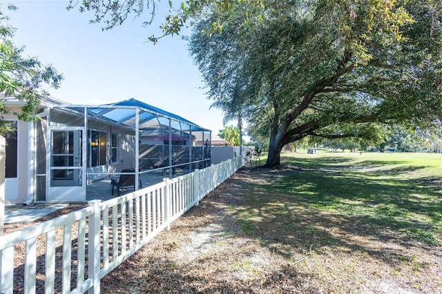 view of yard featuring glass enclosure