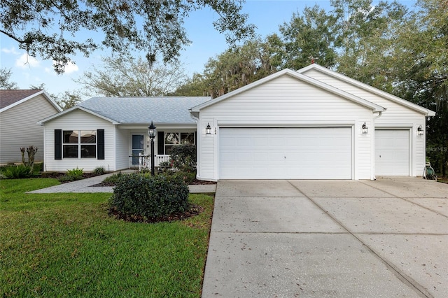 ranch-style home featuring a garage, a front yard, and covered porch