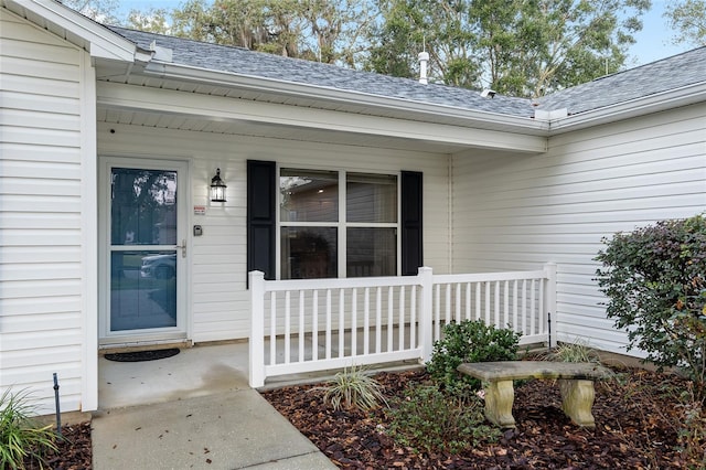 view of exterior entry with covered porch