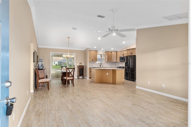 kitchen featuring light hardwood / wood-style floors, black fridge, ornamental molding, hanging light fixtures, and a kitchen island