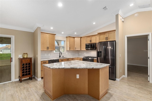 kitchen with stainless steel appliances, a center island, vaulted ceiling, sink, and ornamental molding