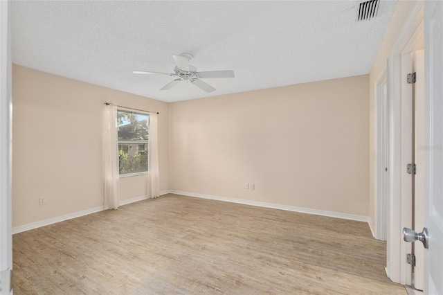 unfurnished room featuring light hardwood / wood-style floors, ceiling fan, and a textured ceiling