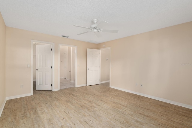 unfurnished bedroom featuring a textured ceiling, light hardwood / wood-style floors, and ceiling fan