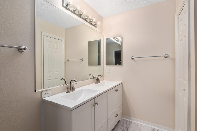 bathroom with vanity and a textured ceiling