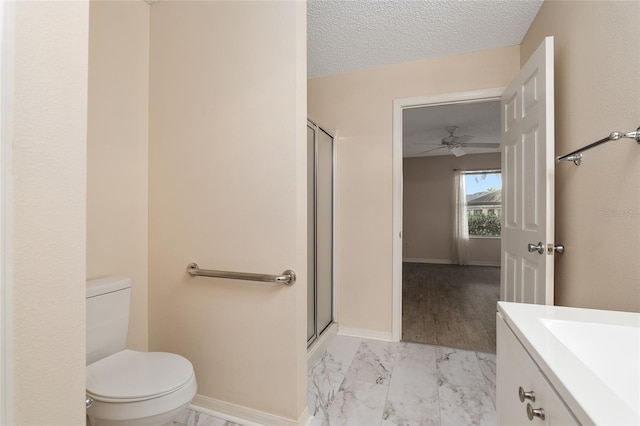 bathroom featuring walk in shower, ceiling fan, a textured ceiling, vanity, and toilet