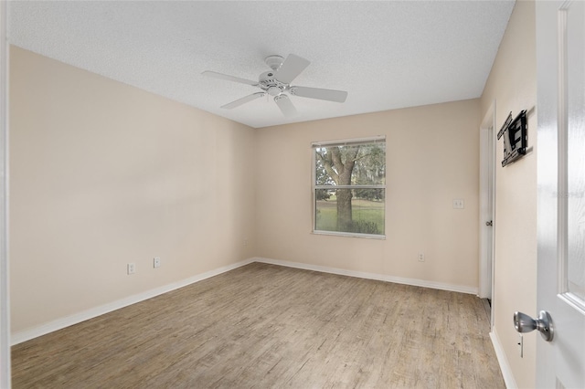 unfurnished room featuring light hardwood / wood-style floors, ceiling fan, and a textured ceiling