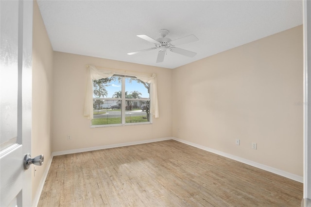 empty room with light wood-type flooring and ceiling fan