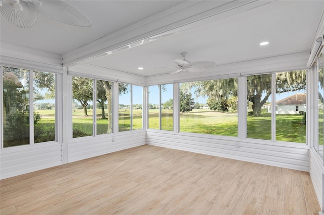 unfurnished sunroom featuring ceiling fan