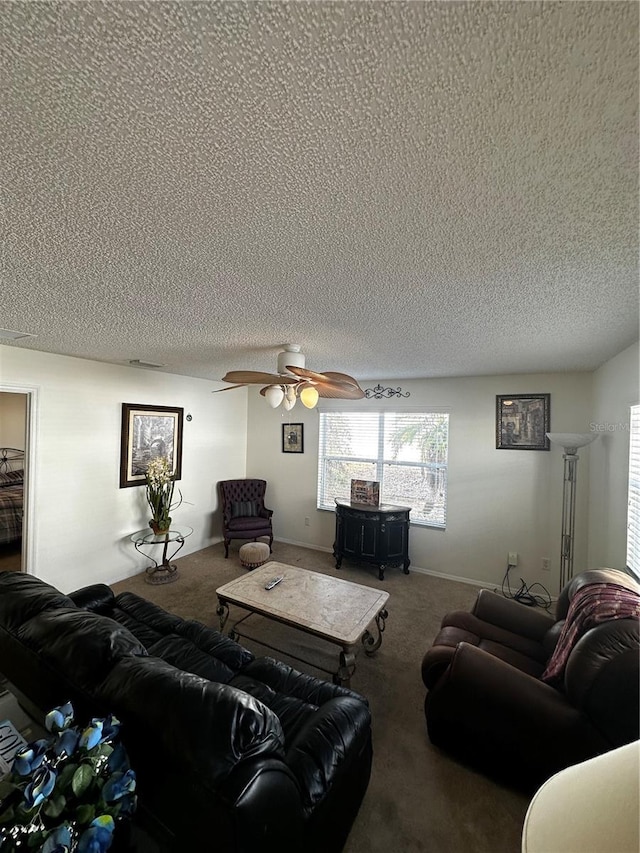 living room with carpet flooring, a textured ceiling, and ceiling fan