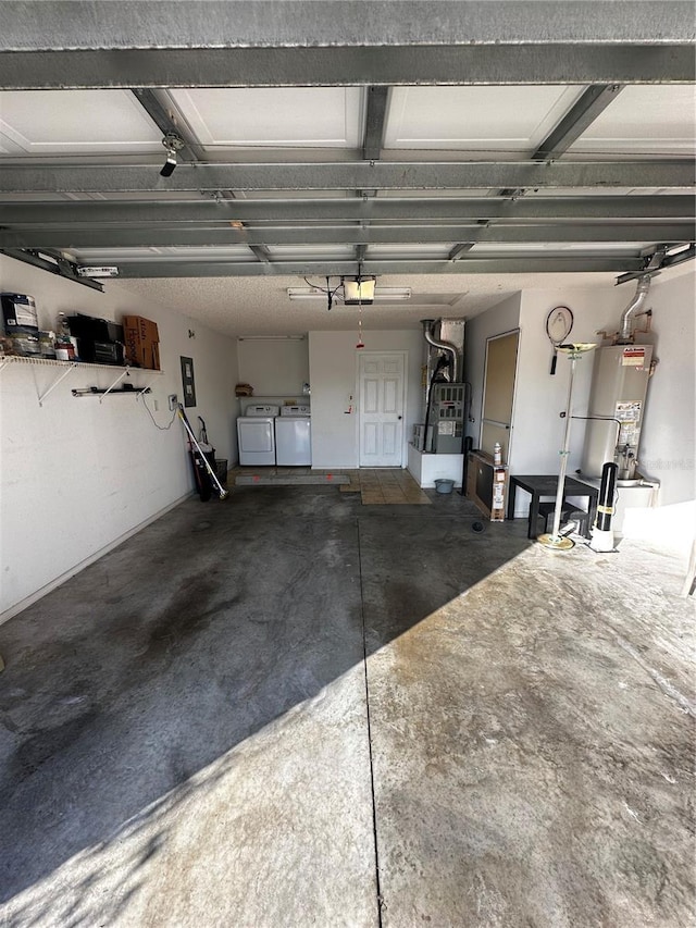 garage with water heater, washer and clothes dryer, and a garage door opener