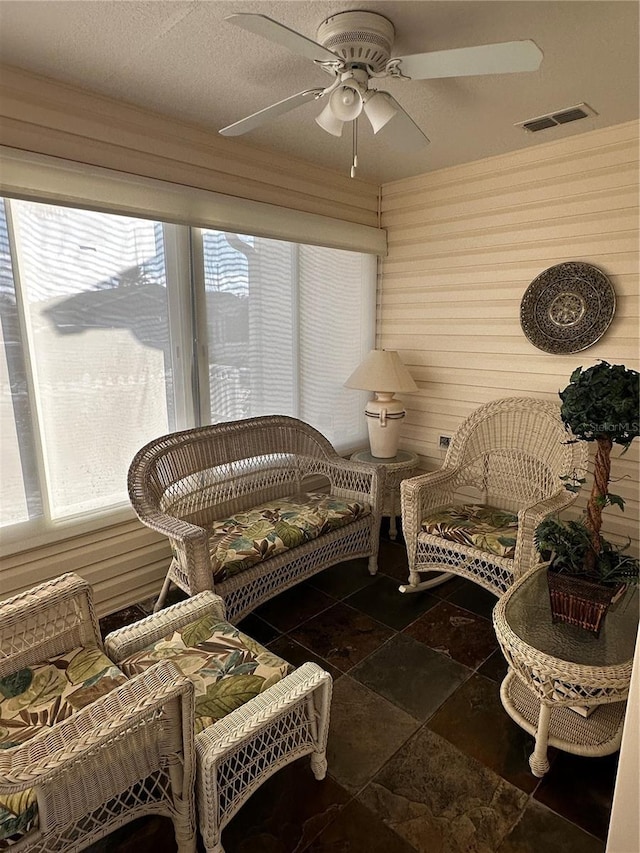 sunroom / solarium with plenty of natural light and ceiling fan